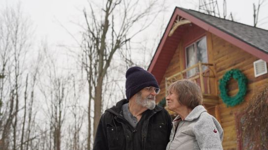 Wanda and Dave Whiting stand outside their home in Lewiston, Michigan.