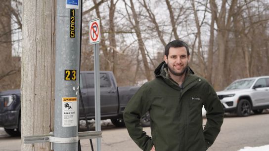 Tony Chartrand, director of electric engineering and operations for Traverse City Light & Power, stands next to a conduit containing an underground wire in Traverse City.