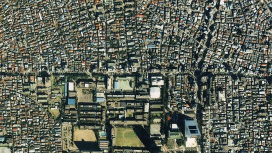 An aerial view of Tokyo, Japan, in 1989 showcases the large amount of surface area taken up by rooftops in urban environments. Widespread implementation of water tank sprinkler systems could put that surface area to good use to diminish urban heat island impacts. An aerial view of Tokyo, Japan, in 1989 showcases the large amount of surface area taken up by rooftops in urban environments. Widespread implementation of water tank sprinkler systems could put that surface area to good use to diminish urban heat island impacts.