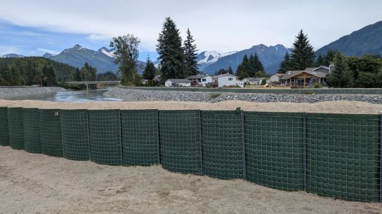 Barriers, installed by the city of Juneau with help from the U.S. Army Corps of Engineers, line the Mendenhall River to protect residential neighborhoods from recurring glacial floods. 