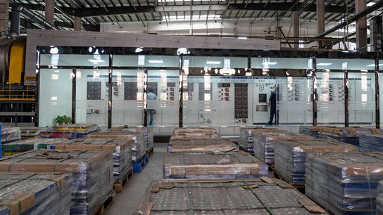 Technicians operate automated recycling equipment at an EV lithium-battery recycling workshop in China in 2023.