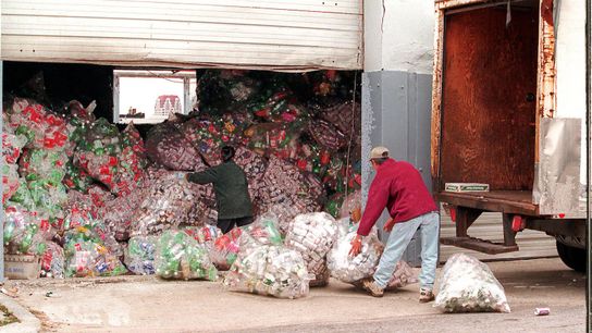 Workers in South Boston load can and bottle returns onto a waiting truck in 1980.