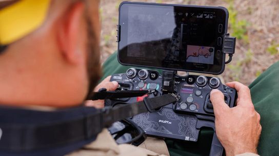 A UAS pilot from the U.S. Forest Service flies a drone using a handheld control system on the Banana Lake wildfire outside of Plains, Montana, on June 6. The pilot is looking for hotspot locations using thermal imagery, which are then passed onto firefighting crews on the ground