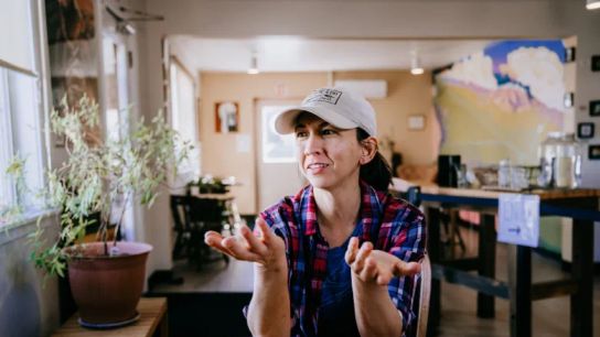 Jessica Larriva sits at a table in her cafe, Tumbleweed Bread, in Monte Vista, Colorado.