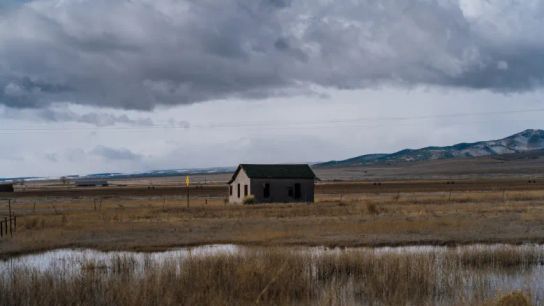 A field and wetland outside of Monte Vista hold water during a stormy spring day in March 2026. Behind the abandoned house, a farmer’s field has not yet been planted.