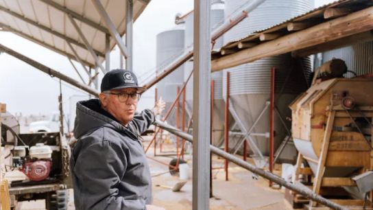 Kris Gosar, owner of Mountain Mama Milling, gives a tour of his mill site outside of Monte Vista, Colorado. Gosar said the clipper cleaner machine behind him is from the 1920s or 30s.