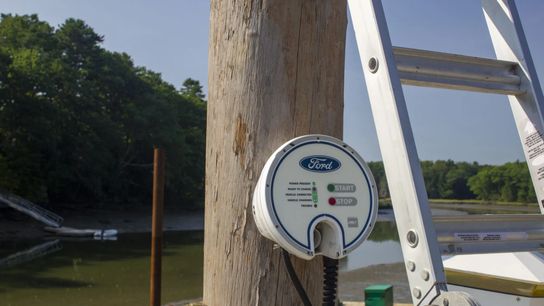A Ford charger provides low-capacity charging to the electric outboard on Chad Strater’s boat at the Sea Meadow Marine Foundation in Yarmouth, Maine. Strater can use the same charger to plug in his Ford Lightning electric truck when he’s at the marina.