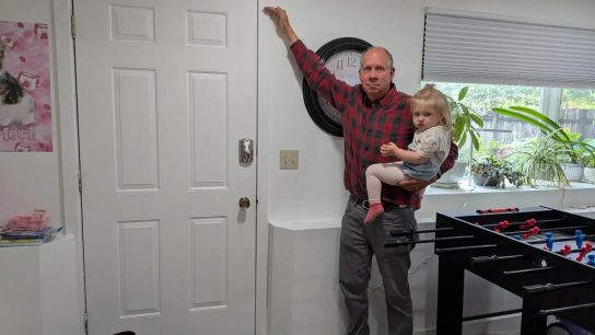 John Lowrey points to how high floodwaters rose inside his home in Juneau during a glacial flood. 