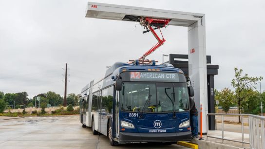A Metro Transit bus parked beneath a pantograph “quick charger” at the end of the line. Just 15 minutes during regularly scheduled layovers allows each coach to travel as far as 258 miles a day. A Metro Transit bus parked beneath a pantograph “quick charger” at the end of the line. Just 15 minutes during regularly scheduled layovers allows each coach to travel as far as 258 miles a day.