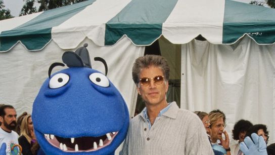Actor Ted Danson poses with Recycle Rex, an educational character developed in cooperation with the California Department of Conservation, at an event in 1993.