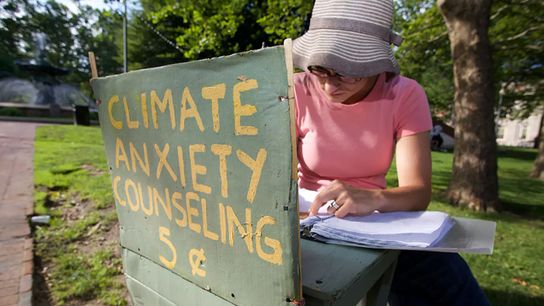 Kate Schapira sits at her climate anxiety counseling booth in 2017.