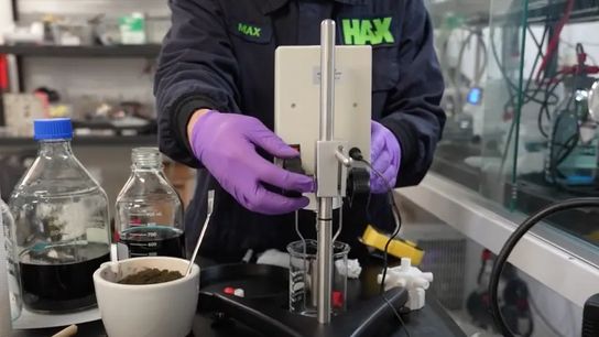 A Still Bright employee sets up a viscometer next to a copper concentrate sample and reagent bottles at the company’s laboratory in New Jersey.